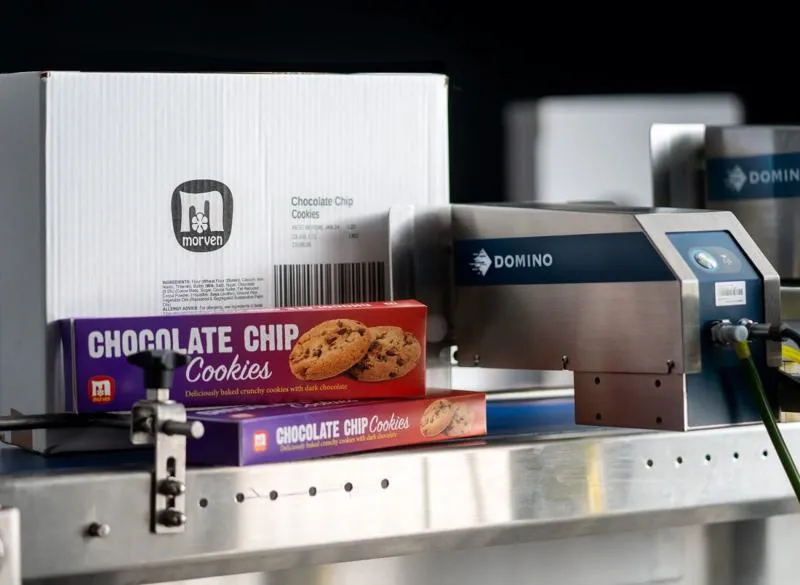 Cx350i printing onto cardboard box next to cookie containers