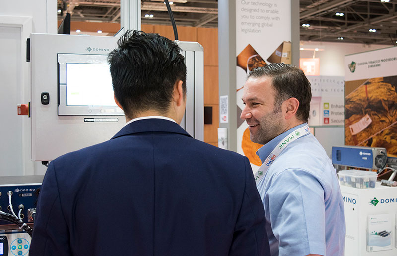 Our Senior Project Manager for the tobacco sector, Sait Ozkan talks with a customer in a trade show