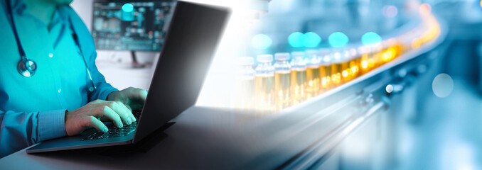 A healthcare professional in a lab coat types on a laptop