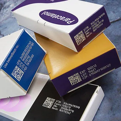 Sample of codes, including data matrix and batch codes, on cardboard pharmaceutical packaging